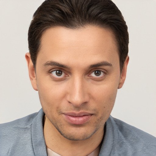 Joyful white young-adult male with short  brown hair and brown eyes