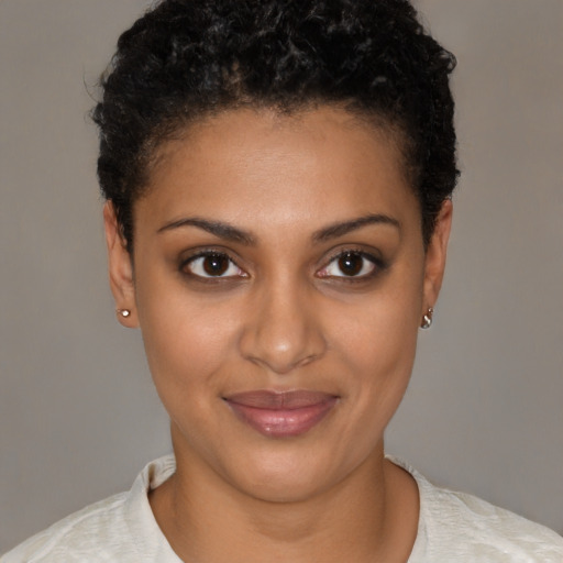 Joyful black young-adult female with short  brown hair and brown eyes