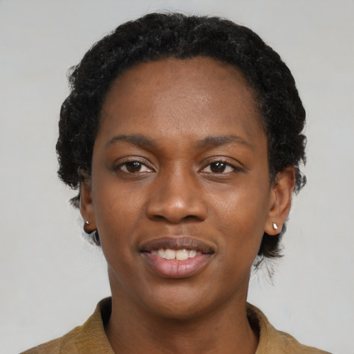 Joyful black young-adult female with short  black hair and brown eyes
