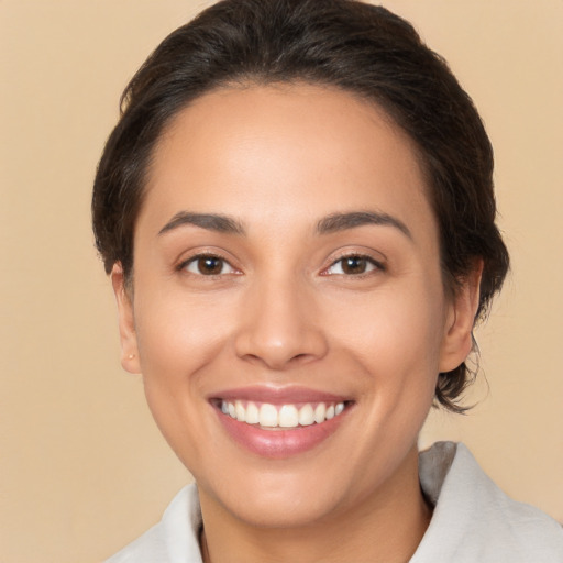 Joyful white young-adult female with medium  brown hair and brown eyes