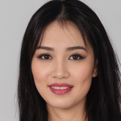 Joyful white young-adult female with long  black hair and brown eyes
