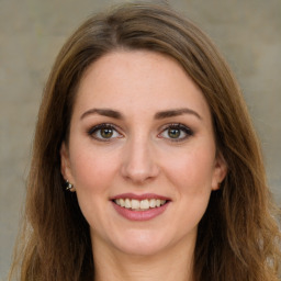 Joyful white young-adult female with long  brown hair and green eyes