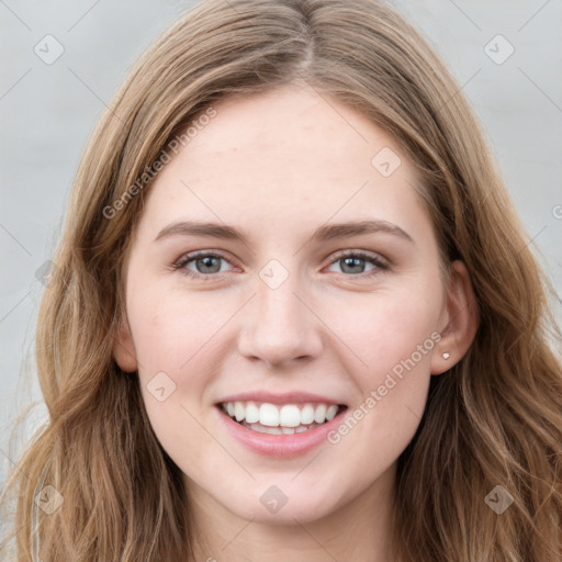 Joyful white young-adult female with long  brown hair and blue eyes