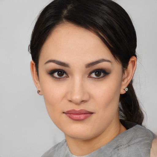 Joyful asian young-adult female with medium  black hair and brown eyes