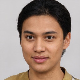 Joyful latino young-adult male with short  brown hair and brown eyes
