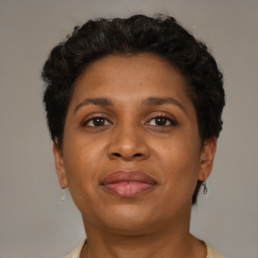 Joyful black young-adult female with short  brown hair and brown eyes