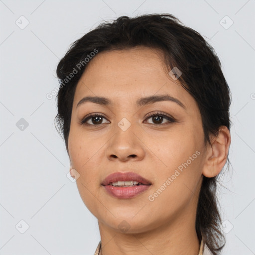 Joyful latino young-adult female with medium  brown hair and brown eyes