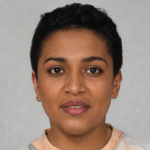 Joyful latino young-adult female with short  black hair and brown eyes