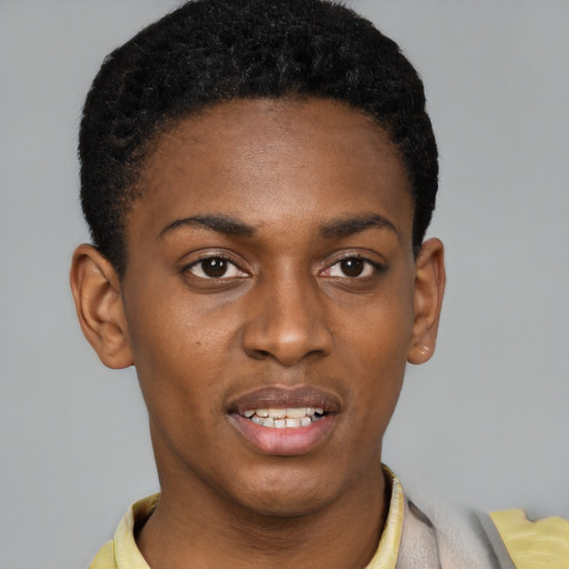 Joyful black young-adult male with short  black hair and brown eyes