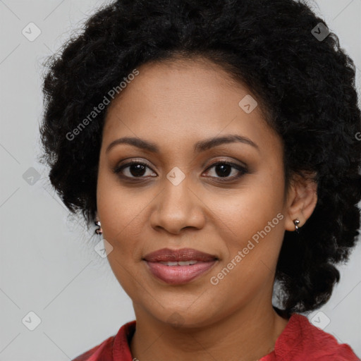 Joyful black young-adult female with long  black hair and brown eyes