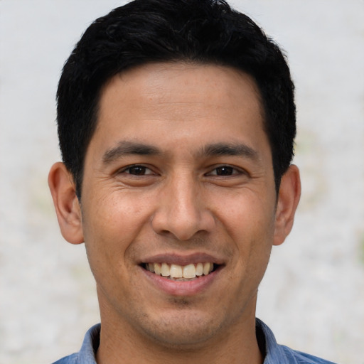 Joyful asian young-adult male with short  black hair and brown eyes