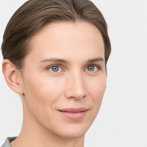 Joyful white young-adult female with short  brown hair and grey eyes