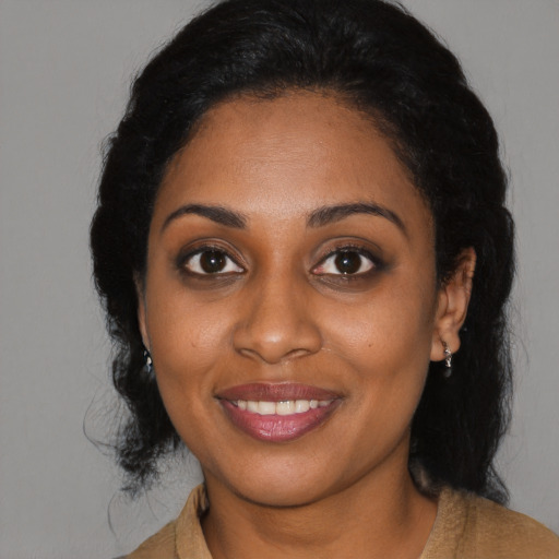 Joyful black young-adult female with medium  black hair and brown eyes