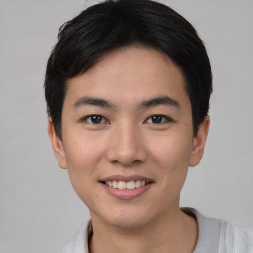 Joyful asian young-adult male with short  black hair and brown eyes