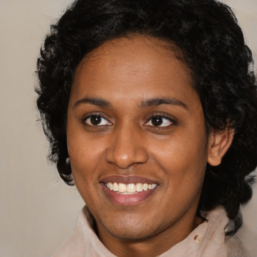 Joyful black young-adult female with medium  brown hair and brown eyes