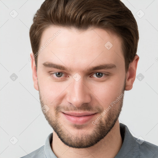 Joyful white young-adult male with short  brown hair and grey eyes