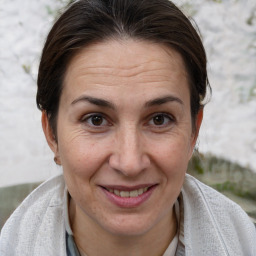 Joyful white adult female with short  brown hair and brown eyes