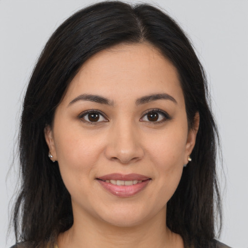 Joyful latino young-adult female with long  brown hair and brown eyes