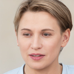 Joyful white young-adult female with short  brown hair and grey eyes