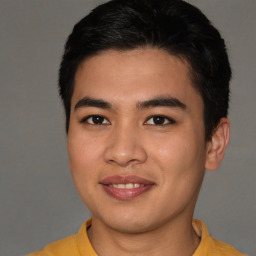 Joyful asian young-adult male with short  brown hair and brown eyes