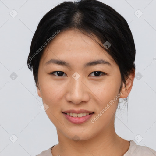 Joyful asian young-adult female with short  black hair and brown eyes