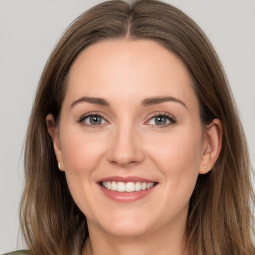 Joyful white young-adult female with long  brown hair and brown eyes