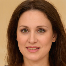 Joyful white young-adult female with long  brown hair and green eyes