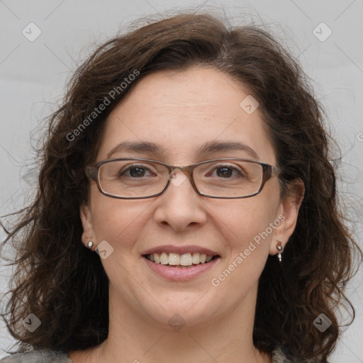 Joyful white adult female with long  brown hair and grey eyes