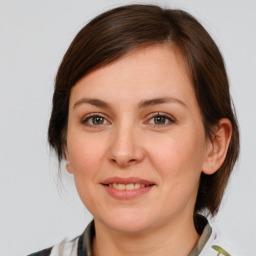 Joyful white young-adult female with medium  brown hair and brown eyes