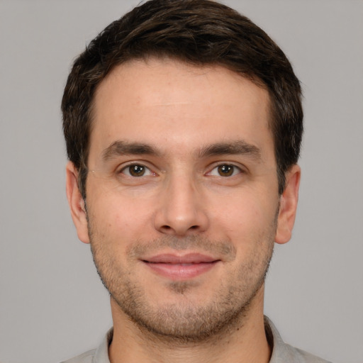 Joyful white young-adult male with short  brown hair and brown eyes