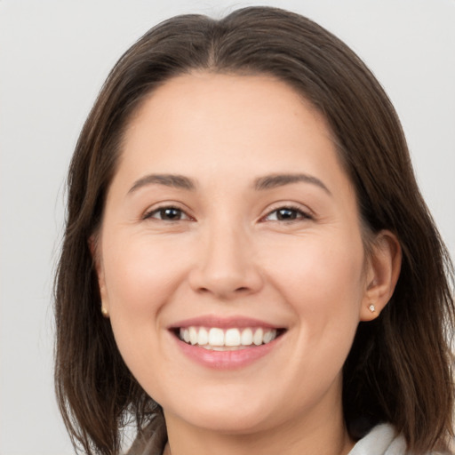 Joyful white young-adult female with medium  brown hair and brown eyes