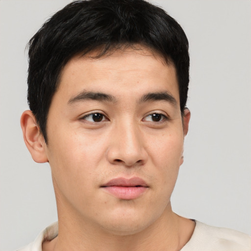 Joyful asian young-adult male with short  black hair and brown eyes