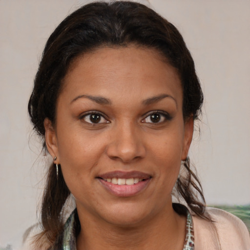 Joyful latino young-adult female with medium  brown hair and brown eyes