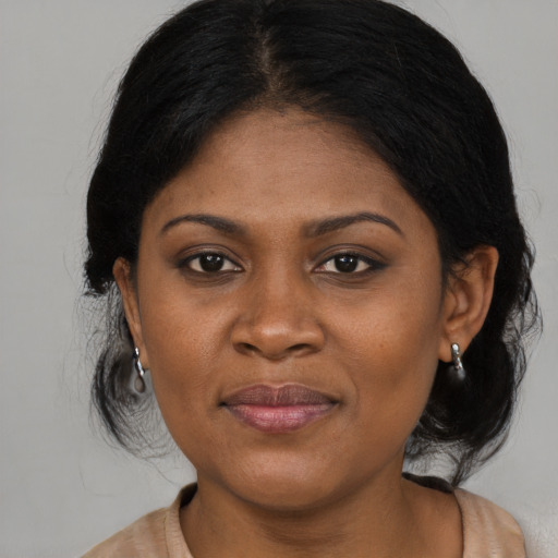 Joyful black adult female with medium  brown hair and brown eyes