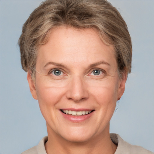 Joyful white adult female with short  brown hair and grey eyes