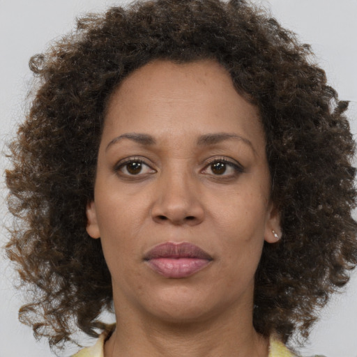 Neutral black adult female with medium  brown hair and brown eyes