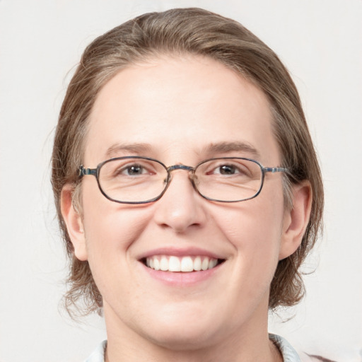 Joyful white adult female with medium  brown hair and blue eyes