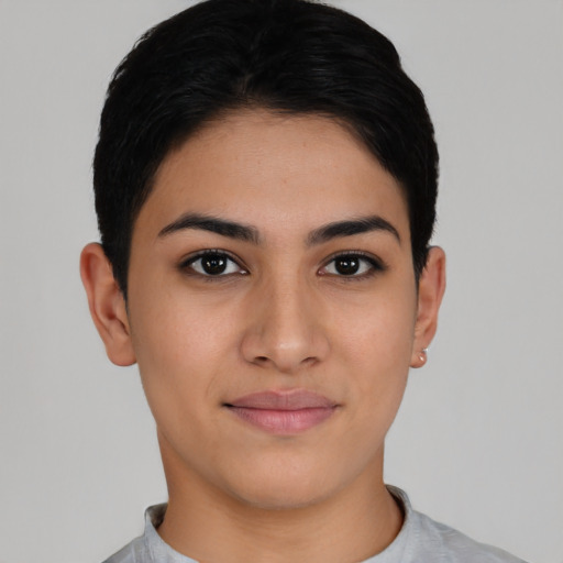 Joyful latino young-adult female with short  black hair and brown eyes