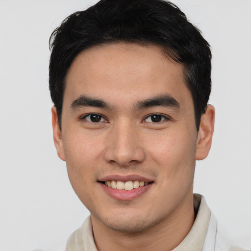 Joyful asian young-adult male with short  brown hair and brown eyes