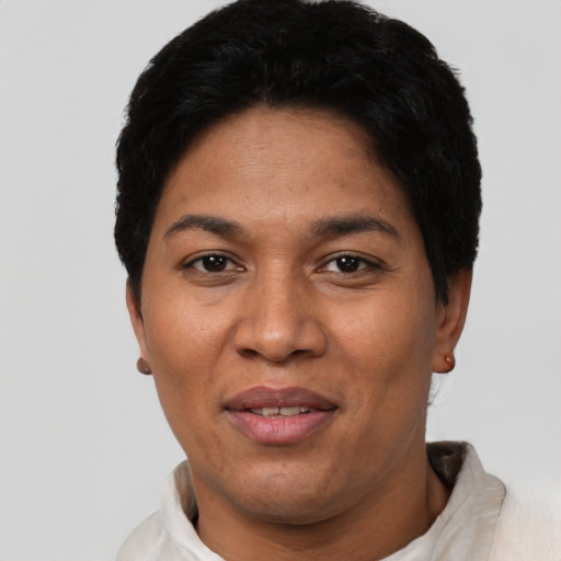 Joyful latino adult female with short  black hair and brown eyes