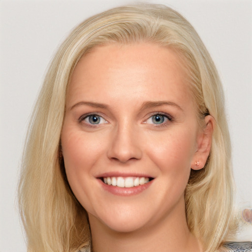 Joyful white young-adult female with medium  brown hair and blue eyes