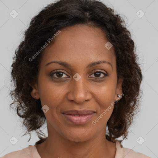 Joyful black adult female with medium  brown hair and brown eyes