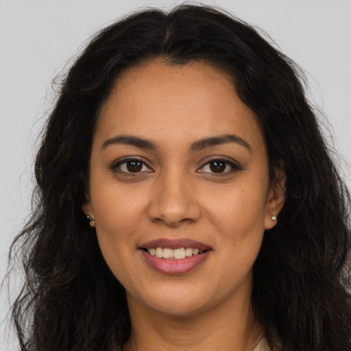 Joyful latino young-adult female with long  brown hair and brown eyes