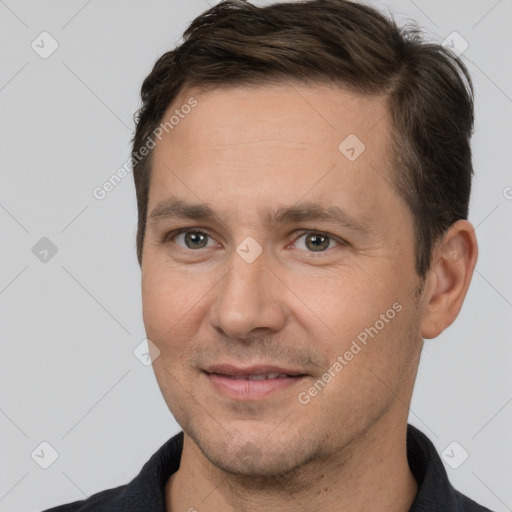 Joyful white adult male with short  brown hair and brown eyes