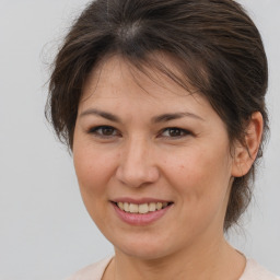 Joyful white adult female with medium  brown hair and brown eyes