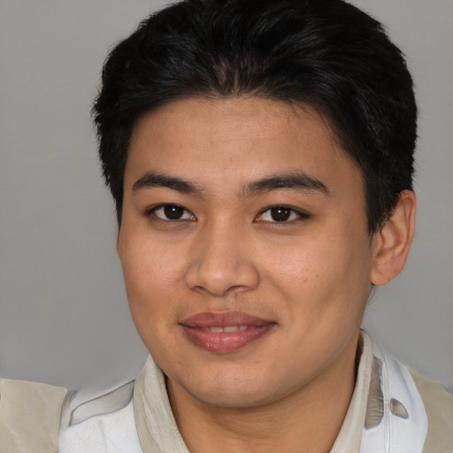 Joyful asian young-adult male with short  brown hair and brown eyes
