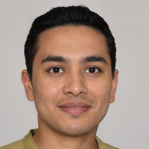 Joyful latino young-adult male with short  black hair and brown eyes