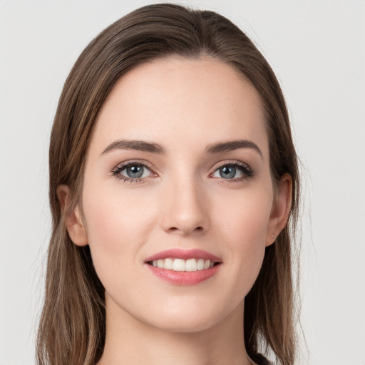 Joyful white young-adult female with long  brown hair and grey eyes