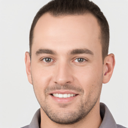 Joyful white young-adult male with short  brown hair and brown eyes