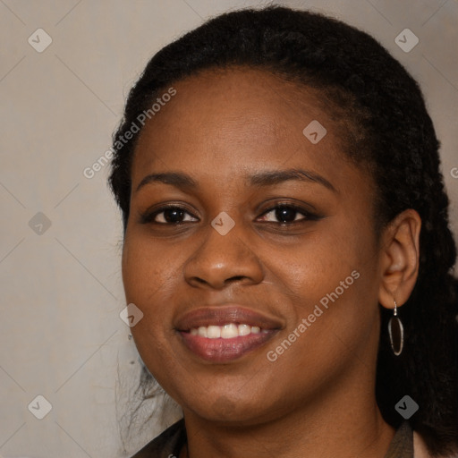 Joyful black young-adult female with long  brown hair and brown eyes